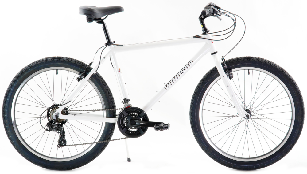 White comfort bike with upright handlebars and rim brakes built for casual neighborhood rides